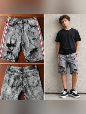 Edgy gray denim shorts featuring distressed detailing and red side stripe accent